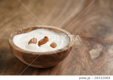 homemade yogurt with almonds in wood bowl on wooden table 28332069