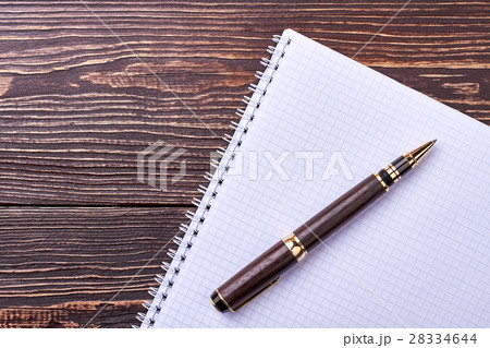 Notebook and pen on wood. 28334644