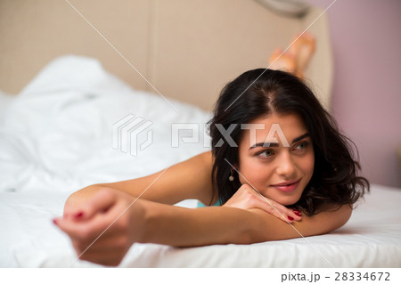 Young female lying in bed. Young female lying in bed. 28334672