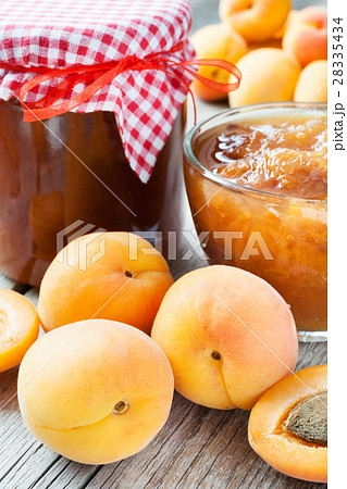 ripe apricot fruits and jar of jam on table ripe apricot fruits and jar of jam on table 28335434