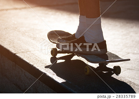 Legs riding a skateboard. Legs riding a skateboard. 28335789