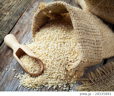 sesame seeds in sack on rustic table sesame seeds in sack on rustic table 28335893