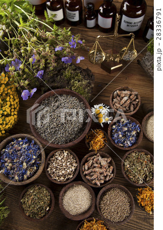 Healing herbs on wooden table, mortar and herbal  28336791