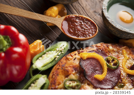 Delicious pizza served on wooden table 28339145