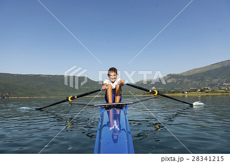 The young sportsman is rowing on the racing kayak 28341215