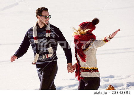 Couple having fun running down slope Couple having fun running down slope 28342395