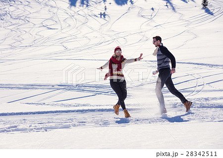 Couple having fun running down slope 28342511