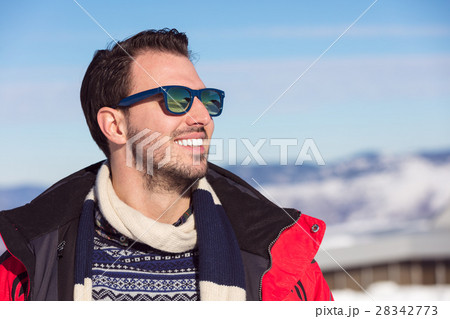 Male portrait on blue sky background on winter 28342773