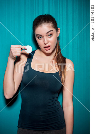 Young girl holding poker chips on blue background Young girl holding poker chips on blue background 28344583
