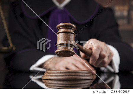 Judge,male judge in a courtroom striking the gavel Judge,male judge in a courtroom striking the gavel 28346067