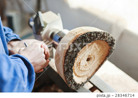 A man working with woodcarving instruments 28346714