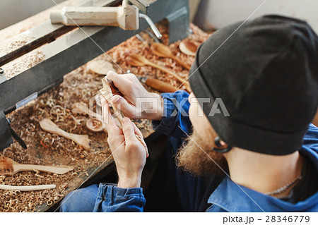A man working with woodcarving instruments A man working with woodcarving instruments 28346779