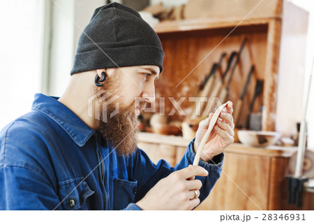 A man working with woodcarving instruments A man working with woodcarving instruments 28346931