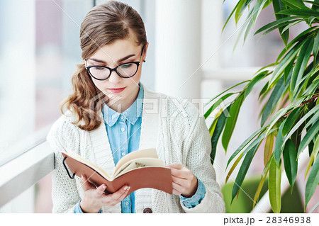 Lovely girl with glasses standing with notebook 28346938