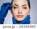 Surgeon drawing dashed lines above eyebrow 28346965
