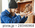 A man working with woodcarving instruments 28346968