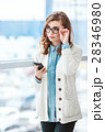 Lovely girl with glasses standing with mobile 28346980