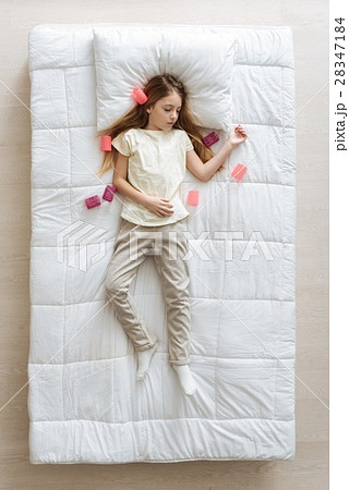 Charming young girl surrounded with hair curlers 28347184
