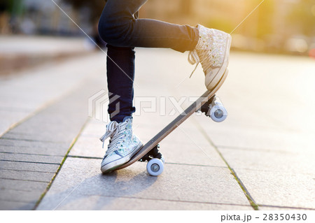Closeup of skateboarder legs. Kid riding skateboard outdoor. Closeup of skateboarder legs. Kid riding skateboard outdoor. 28350430