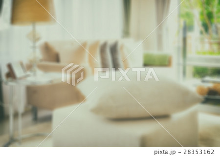 blur of white pillow on stool in living room 28353162