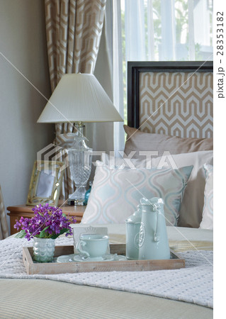 decorative wood tray of tea cup set on bed 28353182