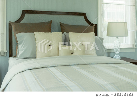 cozy bedroom with white pillows and reading lamp cozy bedroom with white pillows and reading lamp 28353232
