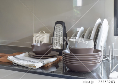 Deep brown ceramic set on black granite counter 28353263