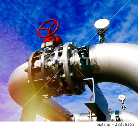 Steel pipelines and valves against blue sky 28356358
