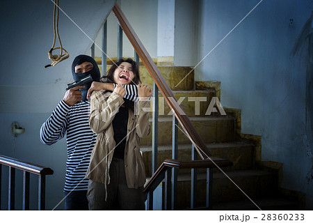 criminal hand holding shot gun woman 28360233