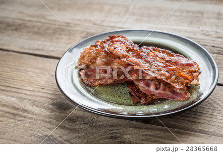 Stack of fried bacon strips on the plate 28365668