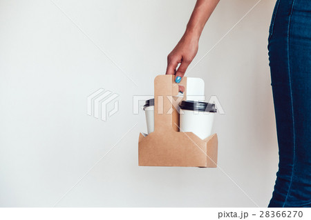 Woman holding a blank takeaway coffee cups white 28366270