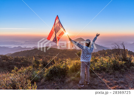 Woman standing on mountain and enjoy sunset view 28369725