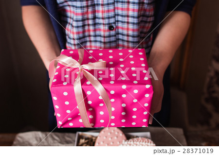 Unrecognizable woman holding pink gift box Unrecognizable woman holding pink gift box 28371019