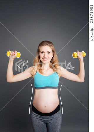 Nice smiling pregnant woman doing sport exercises Nice smiling pregnant woman doing sport exercises 28371901