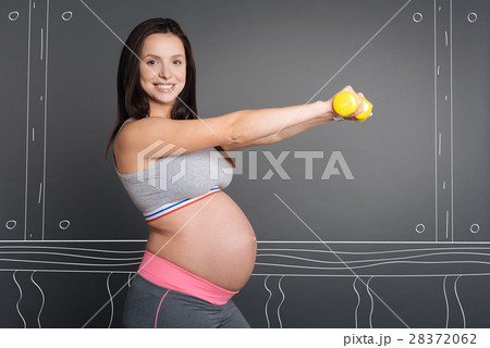 Cherful smiling pregnant woman doing sport Cherful smiling pregnant woman doing sport 28372062