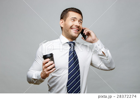 Handsome stylish businessman on grey background 28372274
