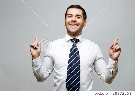 Handsome stylish businessman on grey background 28372352