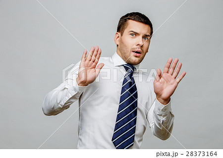 Handsome stylish businessman on grey background 28373164