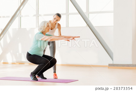 Beautiful female coach training with an elderly Beautiful female coach training with an elderly 28373354