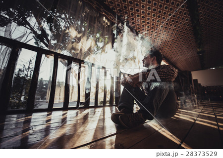 vaping young man produces vapor on sunset vaping young man produces vapor on sunset 28373529