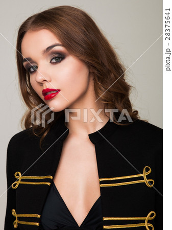 Beautiful fashion model wearing black gold jacket 28375641