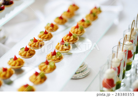 Plates with assorted snacks on an event party Plates with assorted snacks on an event party 28380355