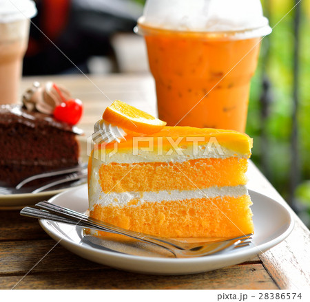 Orange cake and cold drink 28386574