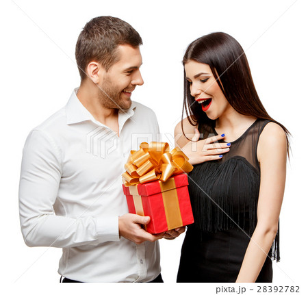 Young beautiful couple with present isolated on Young beautiful couple with present isolated on 28392782
