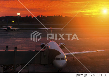 Plane at the airport during sunset 28395104