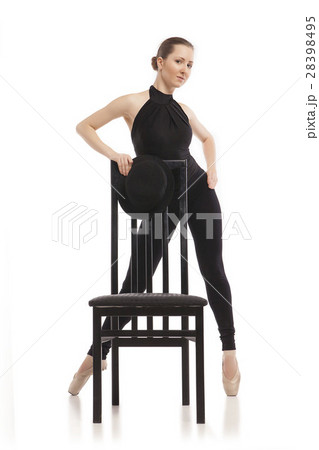 Pretty young ballerina posing with chair. Isolated Pretty young ballerina posing with chair. Isolated 28398495