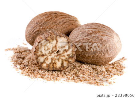 Three nutmeg and powder isolated on white Three nutmeg and powder isolated on white 28399056