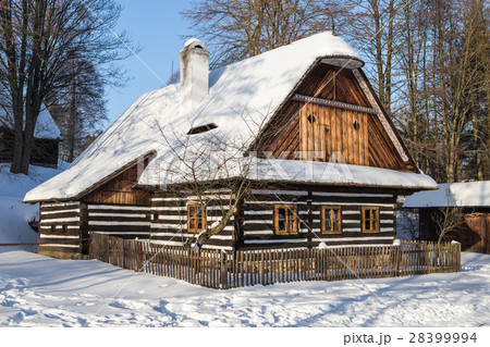 Traditional wooden timbered cottage in winter. Traditional wooden timbered cottage in winter. 28399994