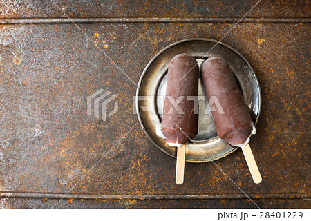 Chocolate covered popsicle on the metal Chocolate covered popsicle on the metal 28401229