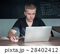 student is preparing for a lecture in classroom 28402412